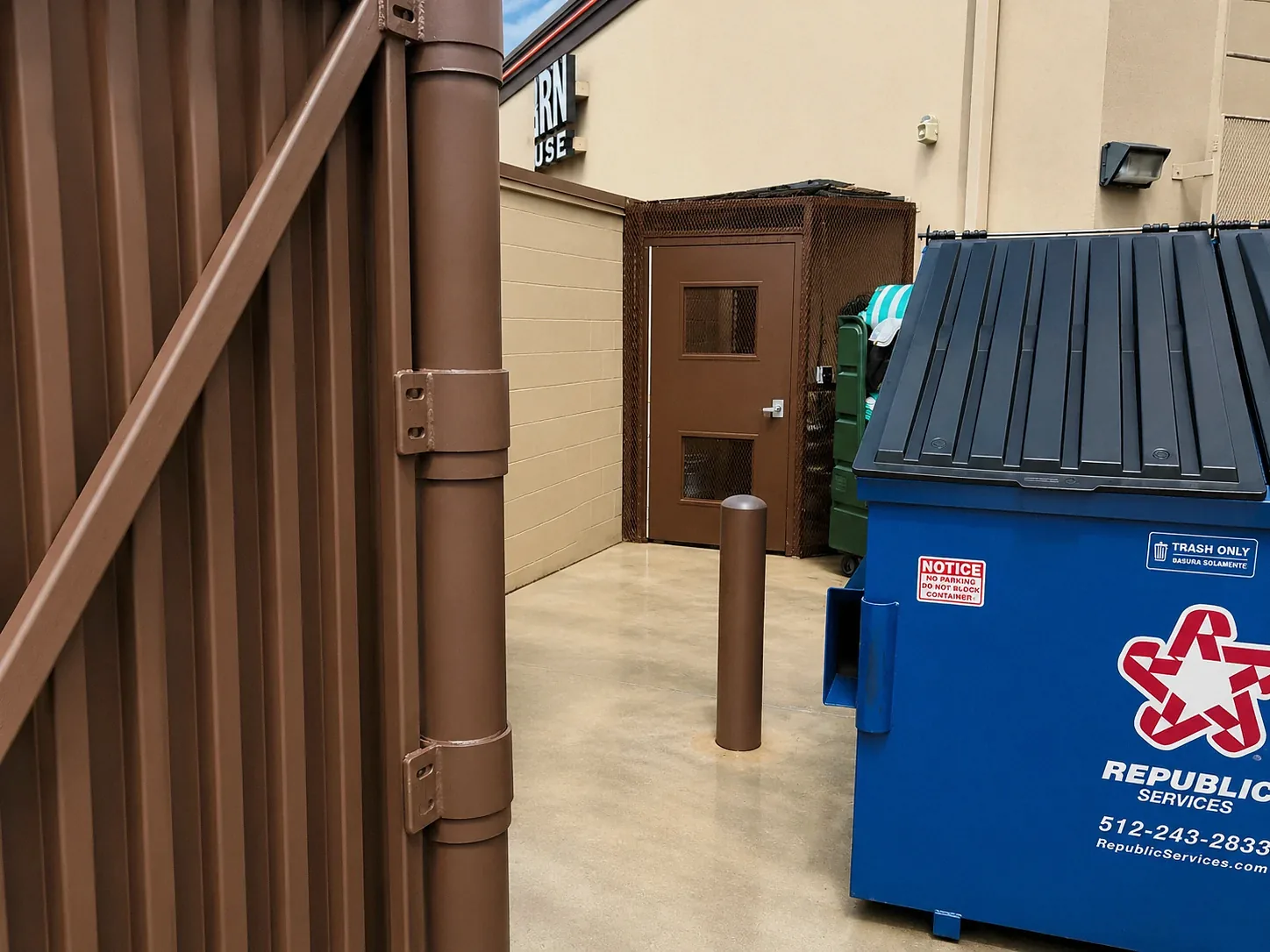 After photo of clean commercial dumpster pad after pressure washing in Austin TX
